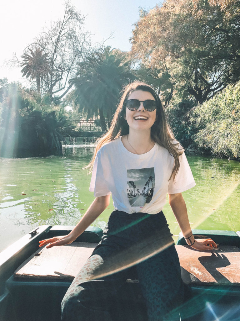 a girl smiling on a rowboat in Ciutadella park, Barcelona