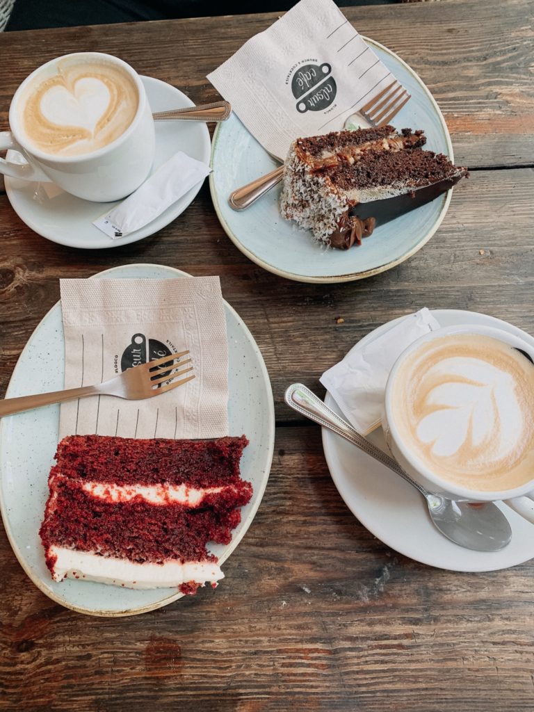 birdseye photo of two coffees and two slices of cake from alsur cafe and backdoor bar in Barcelona