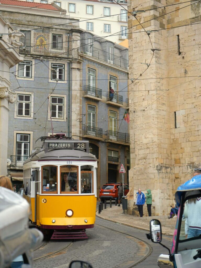 Tram 28 riding through the streets of Lisbon.