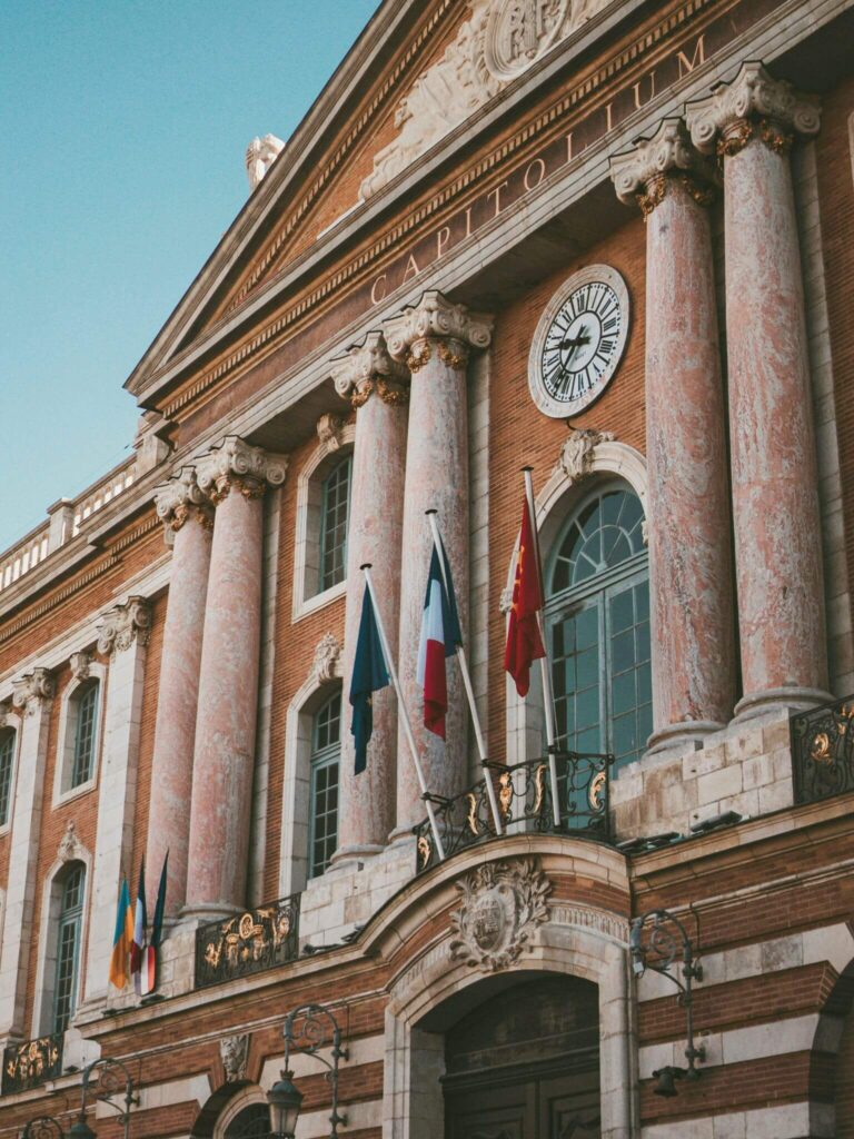 Close up shot of the red-bricked Le Capitole building in Toulouse, France.