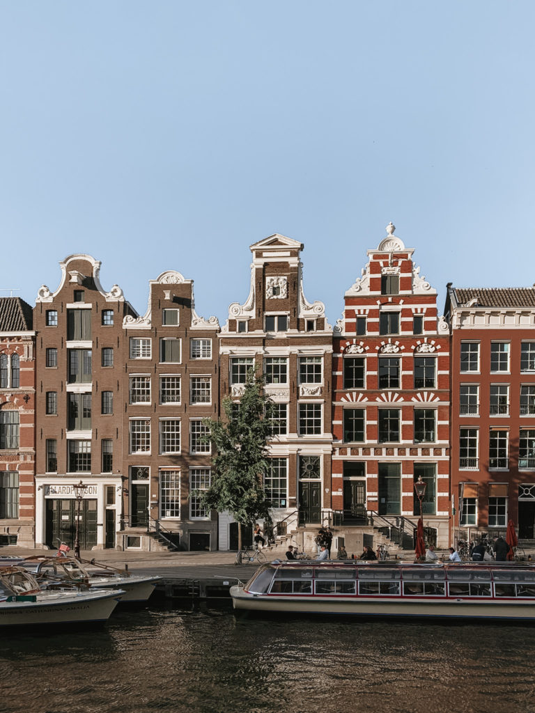 canal houses at Rokin canal with canal boats in the foreground