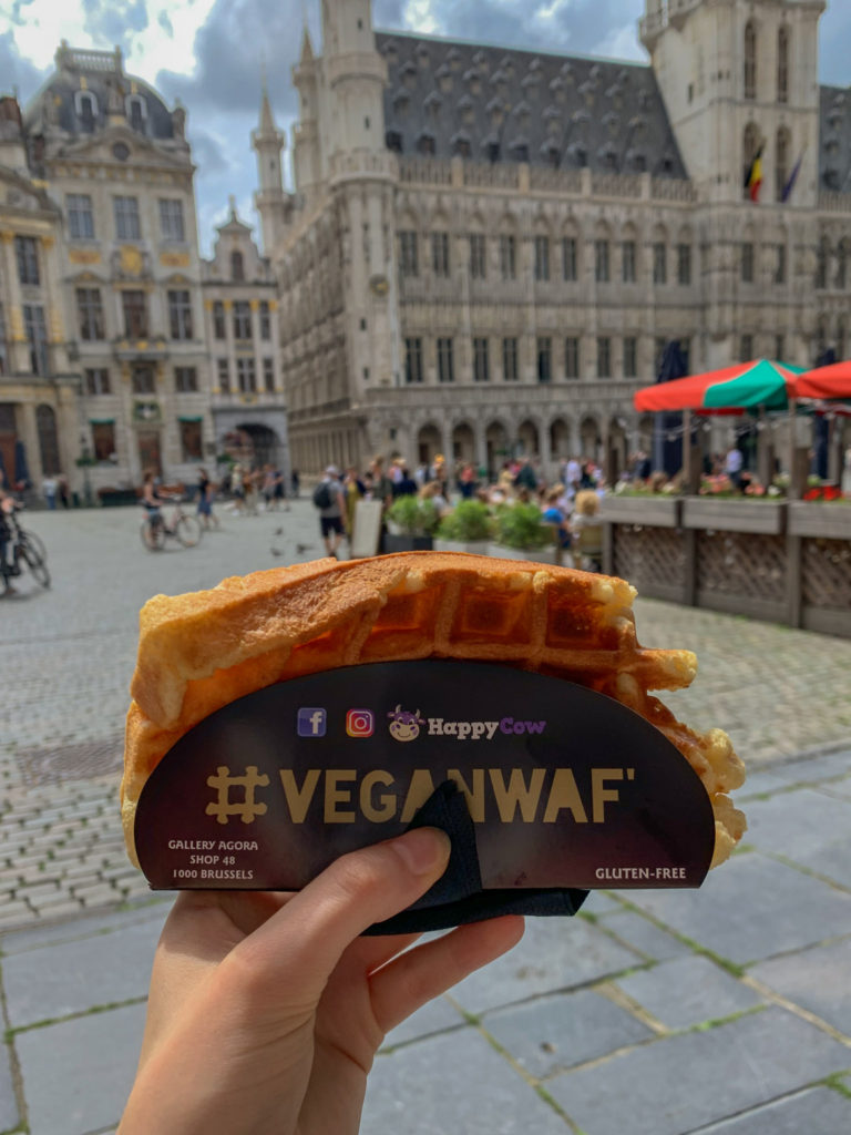you can still try belgian waffles in Brussels if you're vegan - a waffle from veganwaf with grand place in the background
