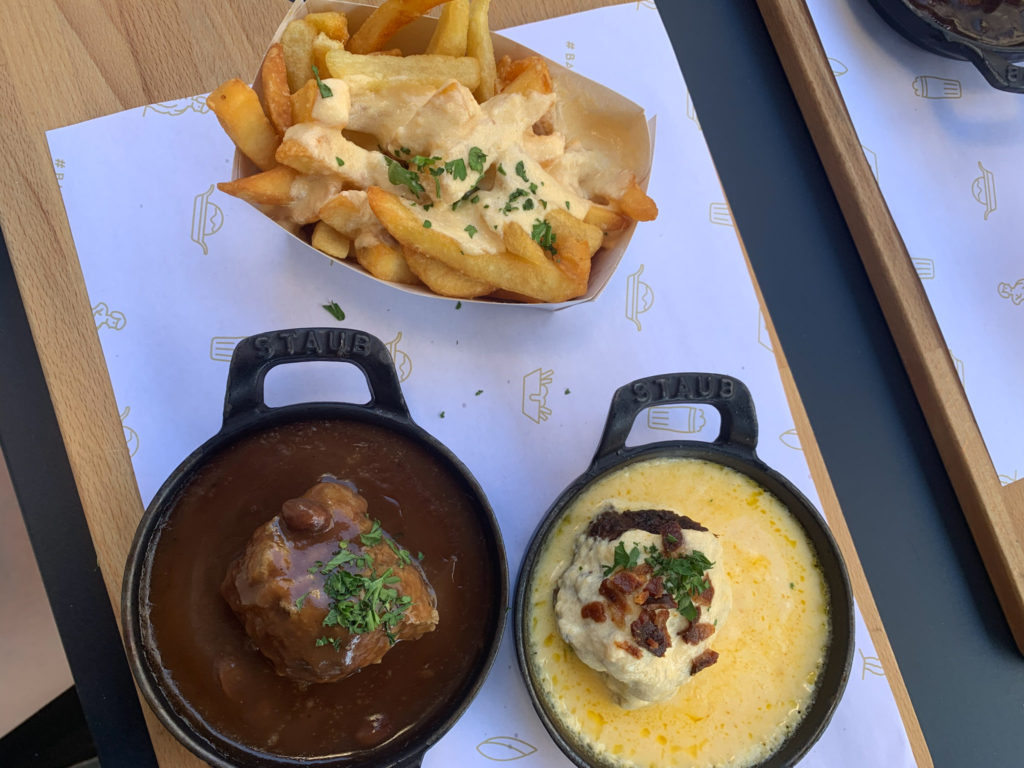 two delicious baked meatballs in sauce with a portion of cheesy fries from Ballekes in Brussels, Belgium