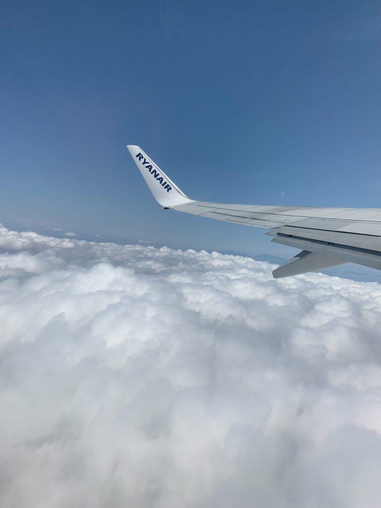 the wing of a Ryanair plane in the clouds