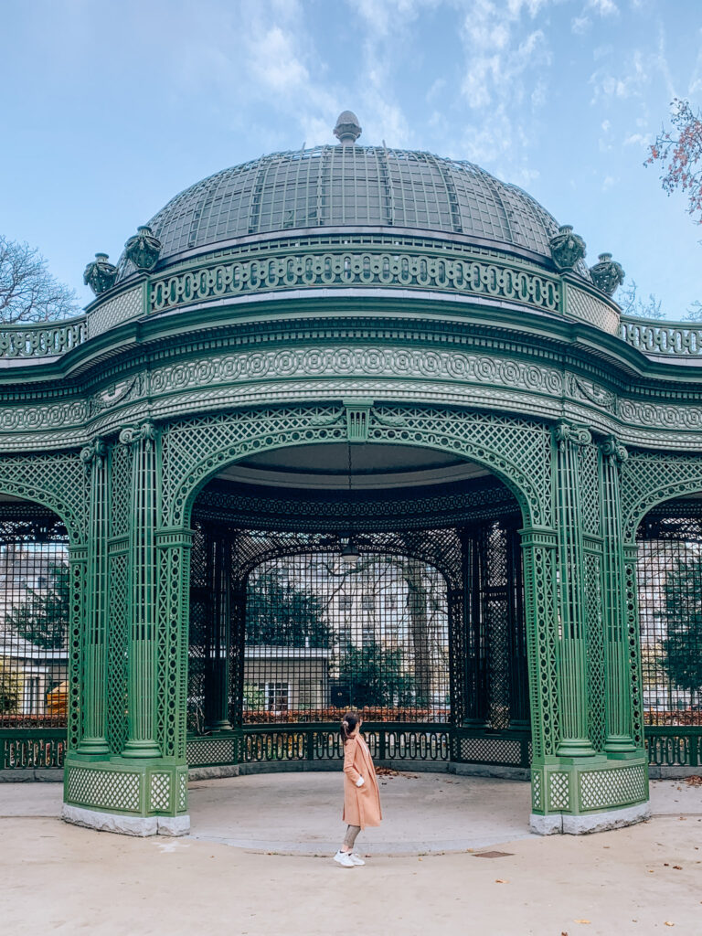 a girl stands beneath the Vaux Hall bandstand in Royal Park, Brussels