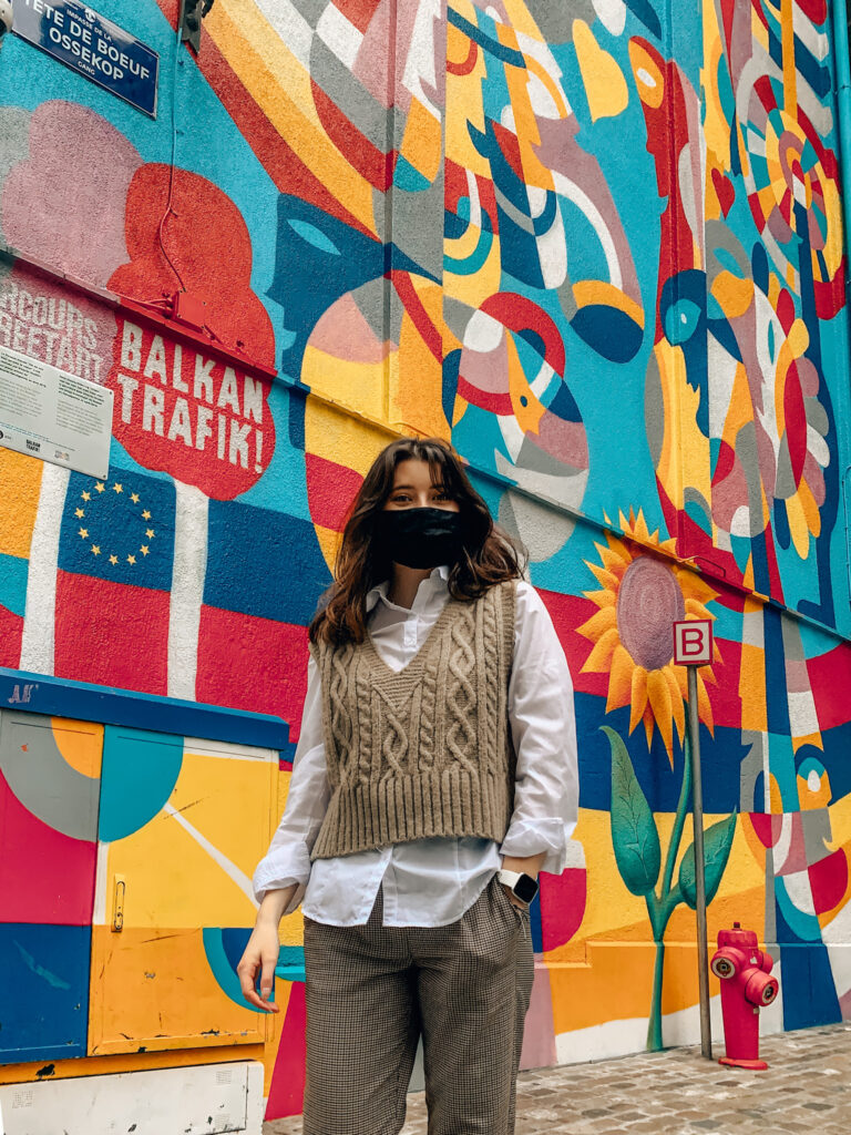 A girl stands in front of the 2019 Balkan Trafik Mural, one of the most unique photo spots in Brussels
