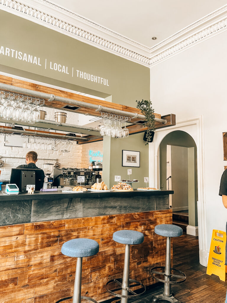 the interior of salt cafe in Edinburgh, with a bar with homemade cakes on display