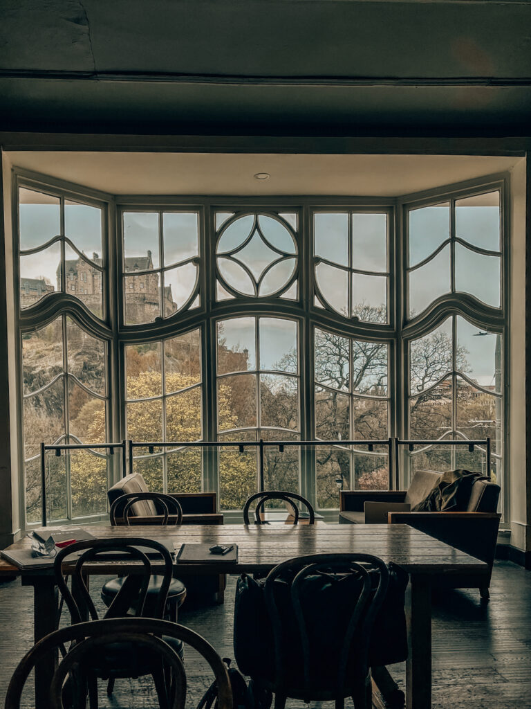 The window of Starbucks on Princes Street in Edinburgh, looking out to Princes Street Gardens and Edinburgh Castle