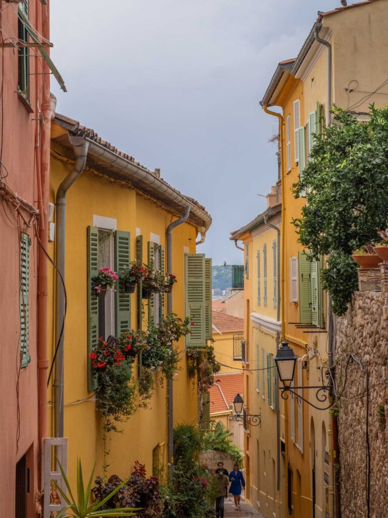 Yellow houses on an old town street in Menton, a town on the French Riviera