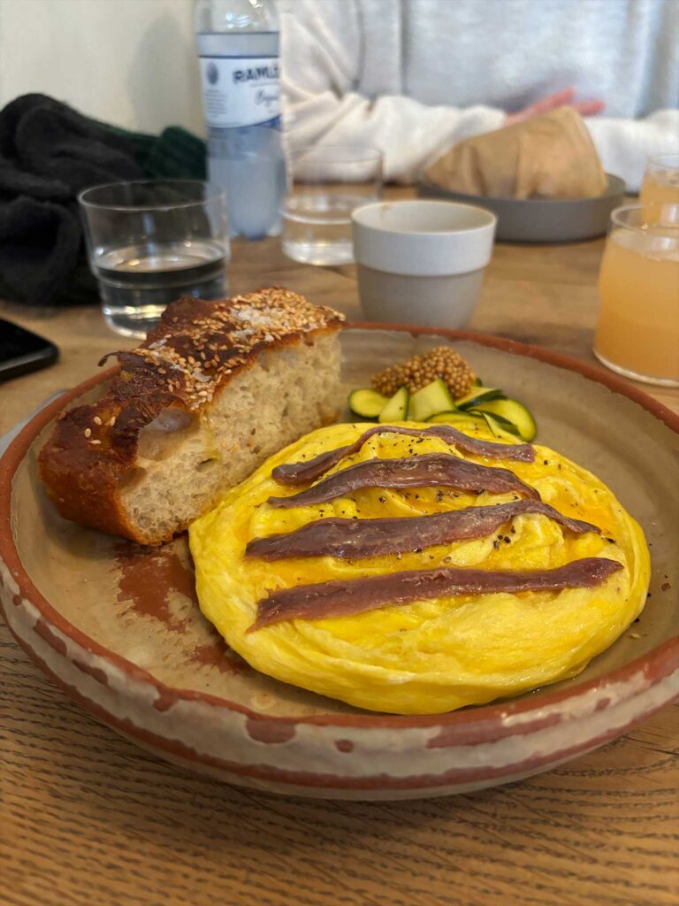 A plate of folded eggs with bread, from studio x kitchen in Copenhagen