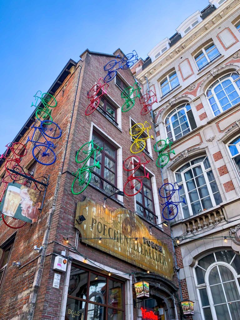 The exterior of Poechenellekelder, one of the best bars in Brussels, with its colourful bicycles