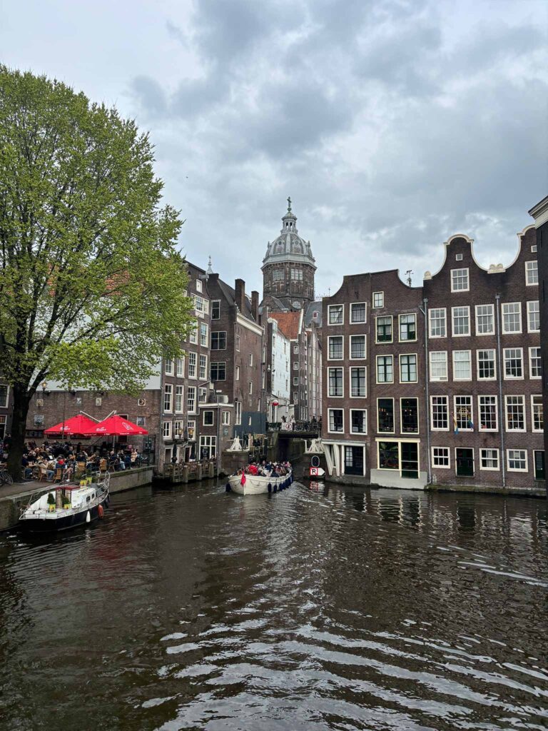 A canal in Amsterdam with boats and houses