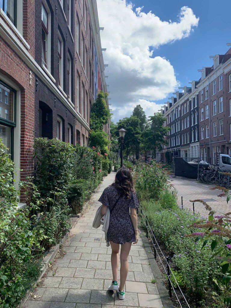 A girl wandering the streets of De Pijp on a weekend in Amsterdam